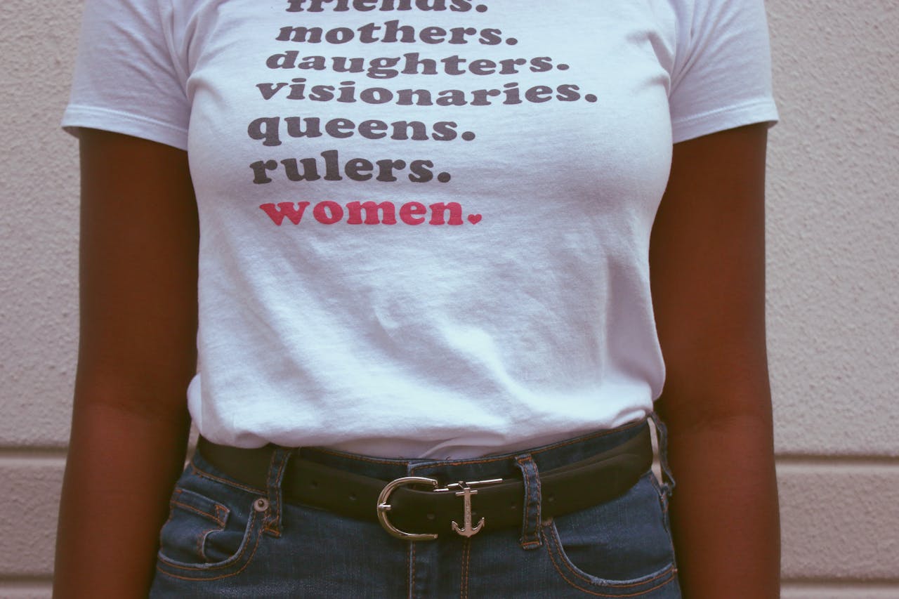 hero-img-01 Close-up of a t-shirt celebrating women's roles and empowerment.